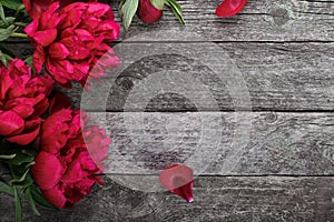 Pink peonies flowers on rustic wooden background. Selective focus