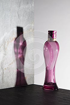 Pink perfume bottle on white background photo