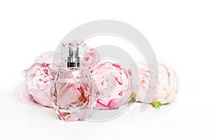 Pink perfume bottle with flowers on light background. Perfumery, cosmetics, fragrance collection