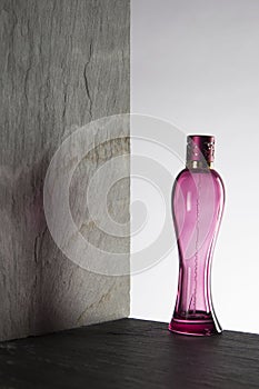 Pink perfume bottle on white background photo