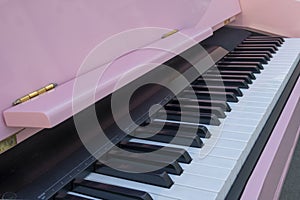 Pink piano. Piano keyboard closeup