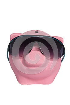Pink pig moneybox wearing sunglasses on a white