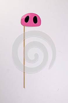 Pink pig nose piggie shape paper die cut selfie portrait party fun paper prop sticker stick on white background photo