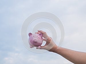 Pink piggy bank on the blue sky with cloud background, Saving money for future plan and retirement fund concept