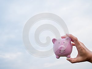 Pink piggy bank on the blue sky with cloud background, Saving money for future plan and retirement fund concept