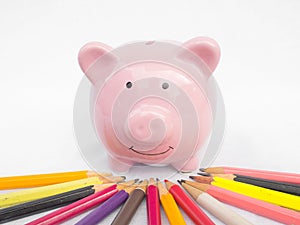 Pink piggy bank with Bright colored pencils, Saving money for future plan and retirement fund concept
