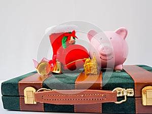 Pink piggy bank on business bag with christmas decoration on white background, Have a nice holiday on this Christmas