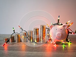 Pink piggy bank with coins pile growth graph and Party lights, Funly saving money for future investment plan and retirement fund