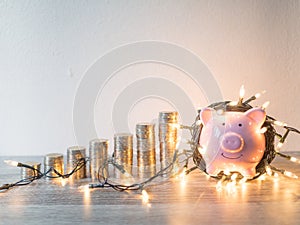 Pink piggy bank with .coins pile growth graph and Party lights, Funly saving money for future investment plan and retirement fund