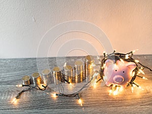 Pink piggy bank with .coins pile growth graph and Party lights, Funly saving money for future investment plan and retirement fund