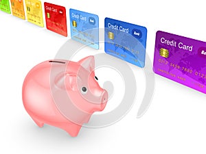 Pink piggy bank and colorful credit cards.