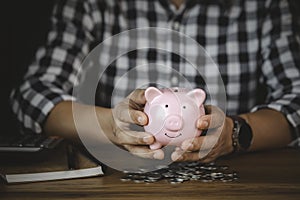 Pink piggy bank on hand for account save money. Planning step up, saving money for future plan