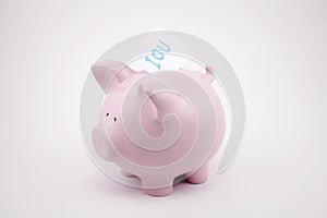 Pink piggy bank with IOU note