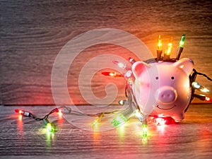 Pink piggy bank with Party lights, Enjoy savings for the holidays concept