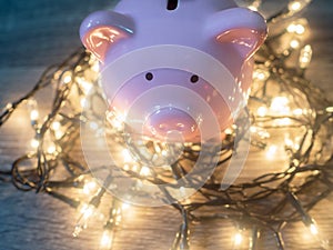 Pink piggy bank with .Party lights, Enjoy savings for the holidays concept