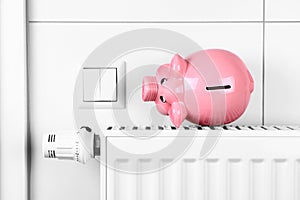 Pink piggy bank saving heating and electricity costs