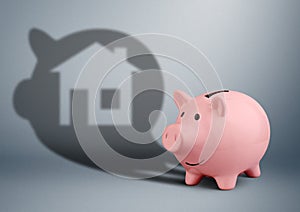 Pink piggy bank with shadow as home, savings for house finance c