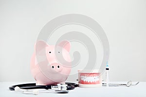 Pink piggy bank with stethoscope