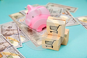 Pink piggy bank, three delievery box and dollar banknotes on blue bakground. Online shopping and delivery service
