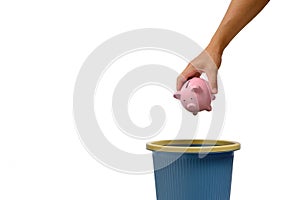 Pink piggy bank is thrown into trash.Concept capital embezzlement bankruptcy