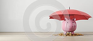 Pink piggy bank under red umbrella with gold coins, saving and insurance concept.