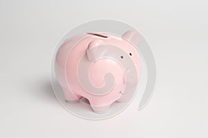 Pink piggy bank on a white background