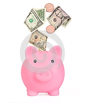 Pink piggy bank wint us dollars and cent coins