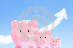 Pink piggy banks with sky and cloud arrow