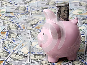 Pink piggybank with American dollars