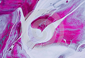 Pink pigment in water on a white background, vortexes and dispersion of a drops of magenta ink in liquid acryli. abstract pattern