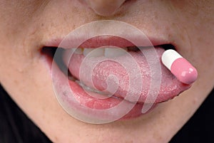 Pink pill on tongue