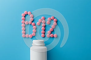 Pink pills in the shape of the letter B12 on a blue background, spilled out of a white can
