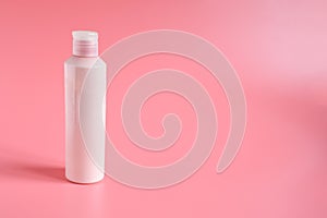 Pink plastic bottle for liquid soap  or bodylotion ,cosmetique on pink background with space for text. Health care and Buiness