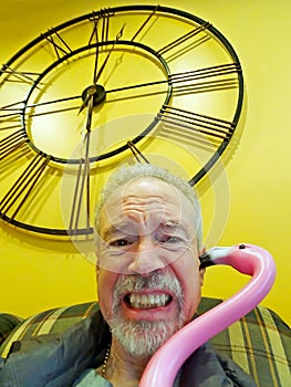 Pink Plastic Flamingo Whispering Into Man`s Ear photo