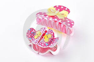 Pink plastic hair clips with bow.