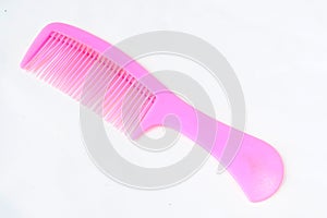 Pink plastic hair comb isolated on white background