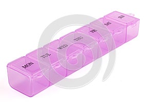 Pink plastic organizer, for pills isolated on white background. Close up on compartments pill case with clip lids medicine. Daily