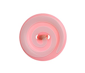Pink plastic sewing button isolated, top view