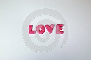 Pink plasticine and clay letters spelling the word Love