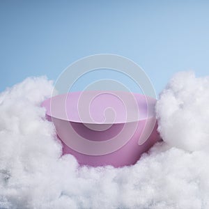 Pink podium with cloud on pastel blue background