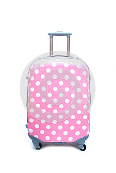 Pink polka dot luggage isolated photo