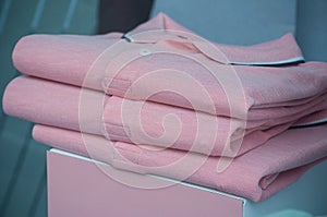 pink polos stack in a men fashion store photo