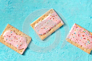 Pink pop tarts on a blue background, top shot