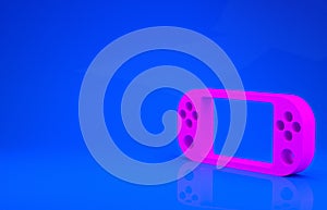 Pink Portable video game console icon isolated on blue background. Gamepad sign. Gaming concept. Minimalism concept. 3d