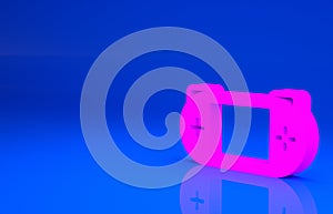 Pink Portable video game console icon isolated on blue background. Gamepad sign. Gaming concept. Minimalism concept. 3d