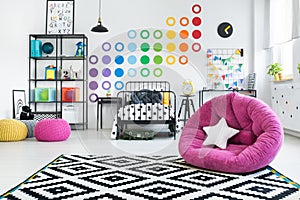 Pink pouf in colorful bedroom photo