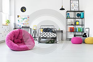 Pink pouf in kid`s room photo