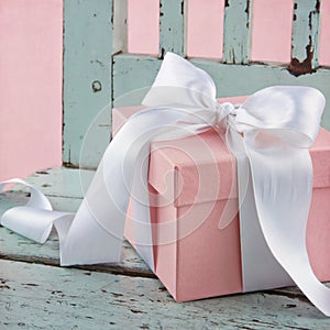 Pink present on a blue wooden chair