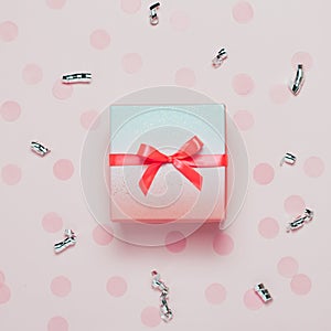 Pink present box on pink konfetti background. photo