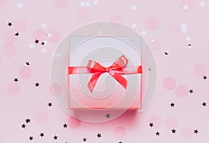 Pink present box on pink konfetti background photo